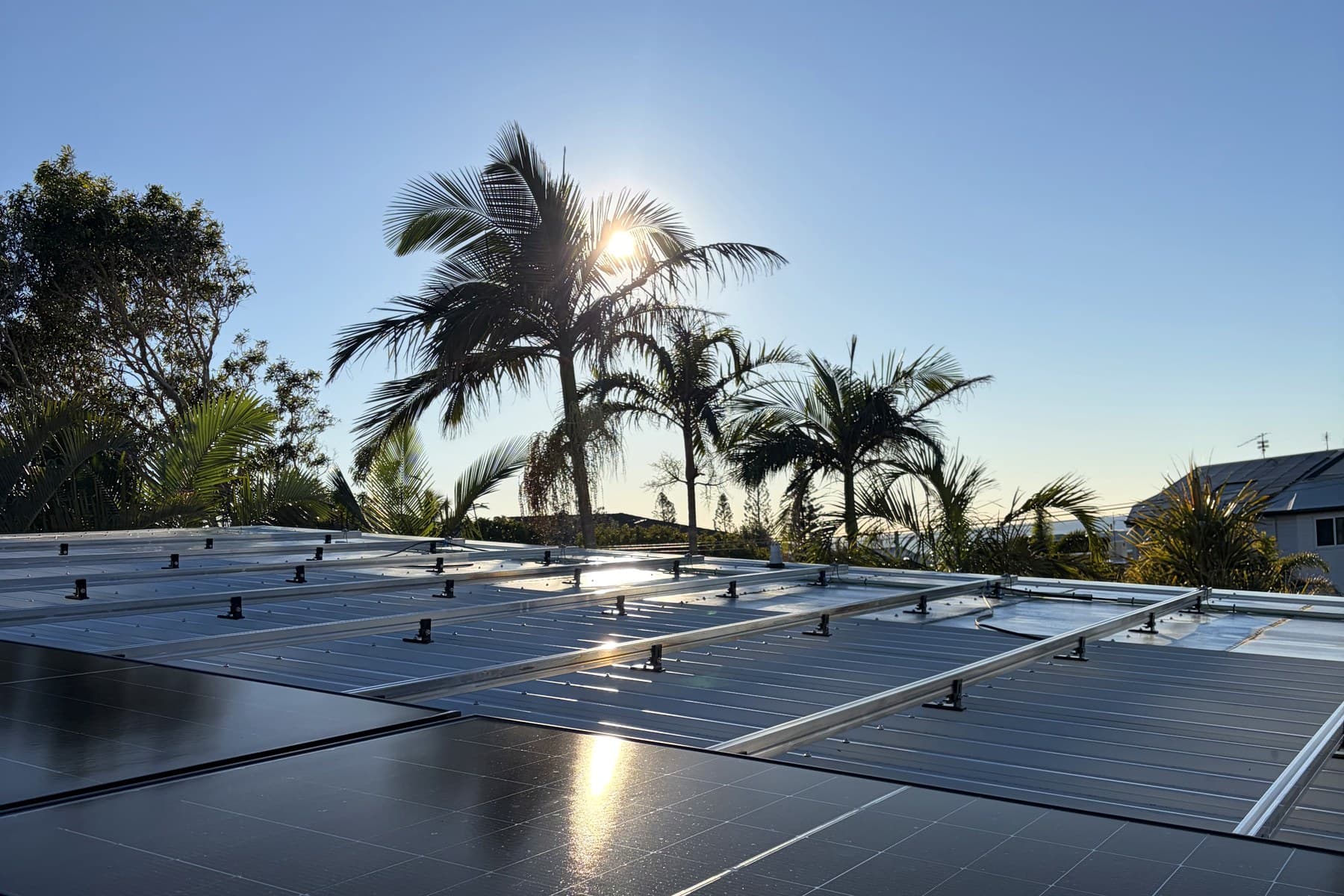 Risen TOPCon bifacial panels installed on a Brisbane rooftop at golden hour